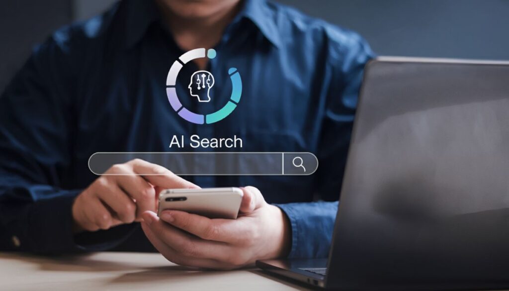 Person using a smartphone in front of a laptop with a digital graphic overlay that reads “AI Search” and displays a neural network icon. The image conveys the concept of AI-powered search tools, relevant to a Google AI overview.