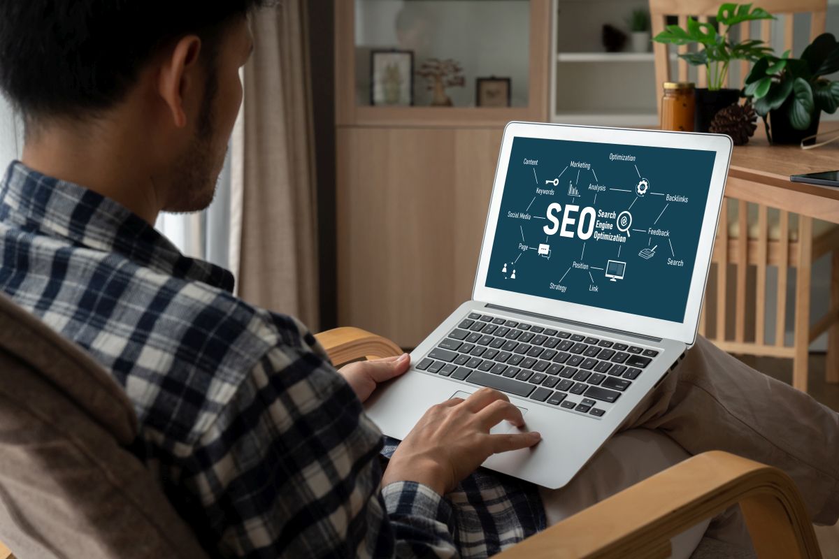 Person using a laptop displaying analytics dashboards and code, representing semantic SEO work and data analysis.